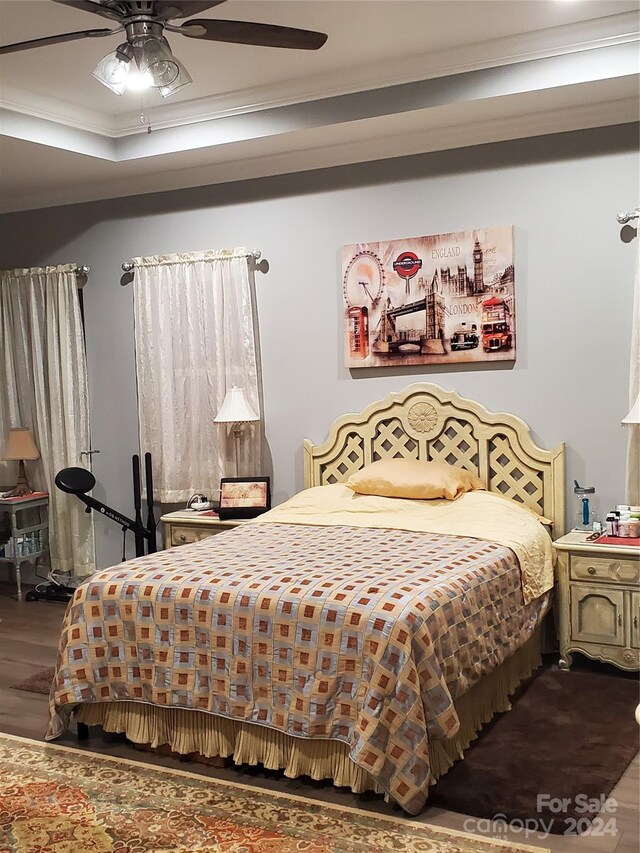 bedroom with ornamental molding, ceiling fan, and hardwood / wood-style floors