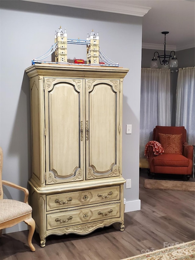 details with a notable chandelier, hardwood / wood-style flooring, and ornamental molding