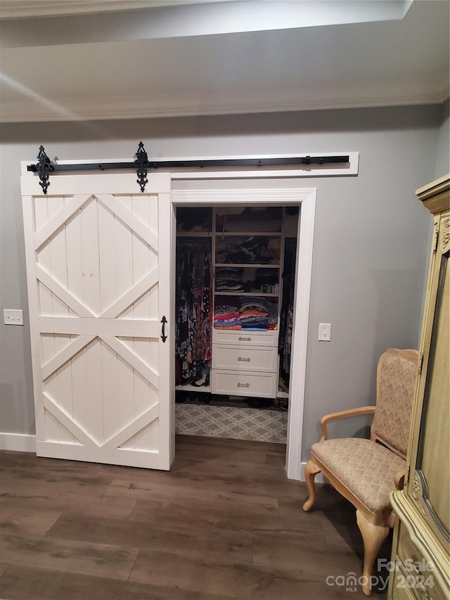 interior space featuring a barn door and dark hardwood / wood-style flooring