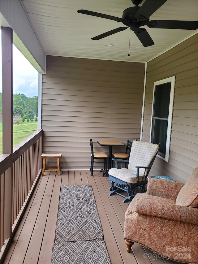 wooden terrace featuring ceiling fan