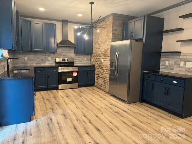 kitchen with wall chimney exhaust hood, stainless steel appliances, blue cabinets, and sink