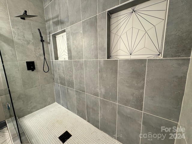 bathroom with tiled shower