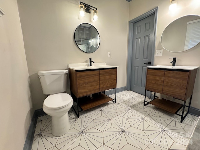 bathroom with tile patterned flooring, vanity, and toilet