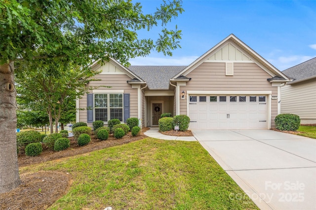 view of front of house with a garage and a front lawn