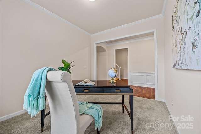 carpeted home office with a decorative wall, a wainscoted wall, and ornamental molding