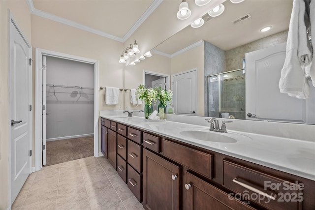 bathroom featuring visible vents, a stall shower, crown molding, and a sink