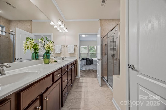 bathroom with a shower stall, visible vents, and a sink