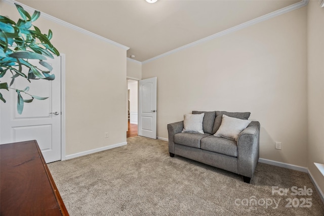 sitting room featuring crown molding, carpet flooring, and baseboards