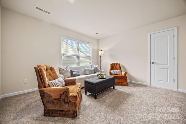 living area featuring visible vents, baseboards, and carpet flooring