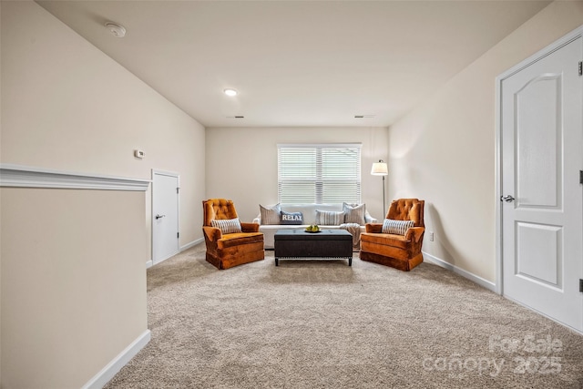 sitting room featuring carpet flooring and baseboards