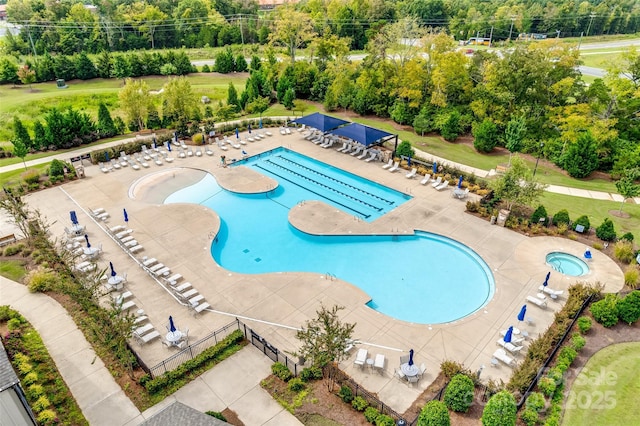 community pool featuring a patio and fence