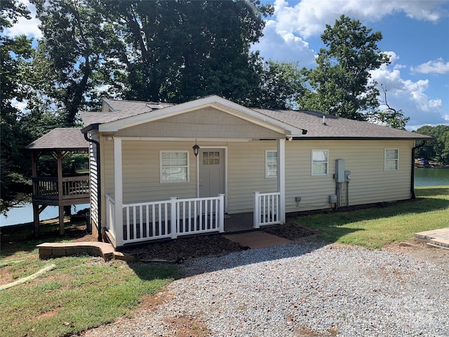 view of front of property with covered porch, a front lawn, and a gazebo