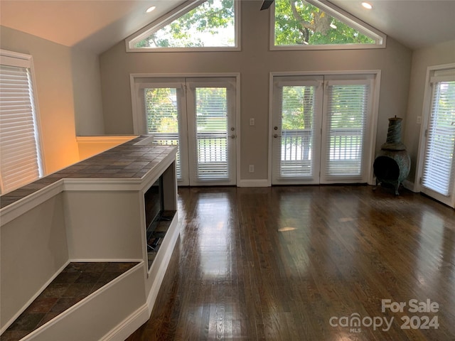 interior space featuring recessed lighting, lofted ceiling, and dark wood finished floors