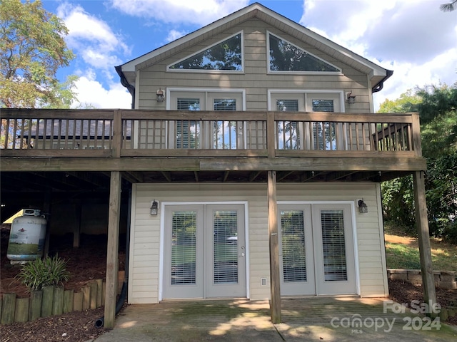 rear view of house featuring a patio and a deck