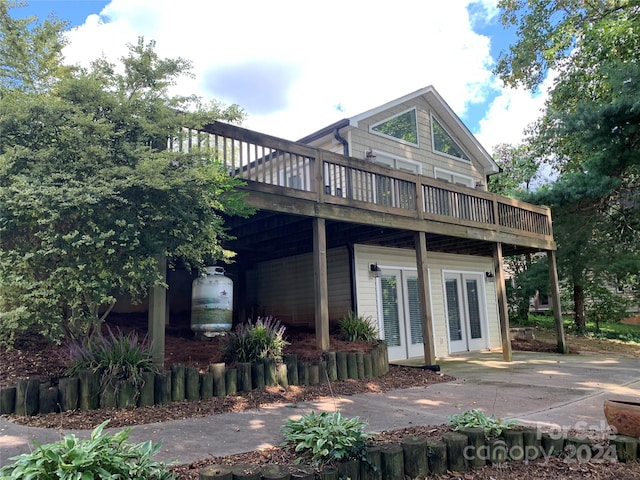 back of property featuring french doors and a deck