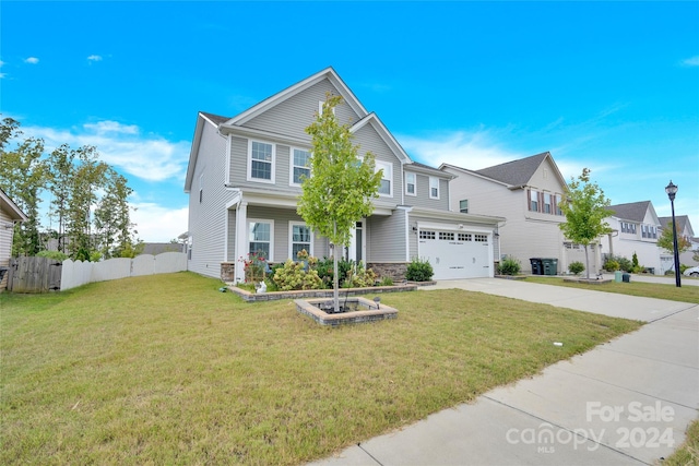 view of front of home featuring a garage and a front lawn