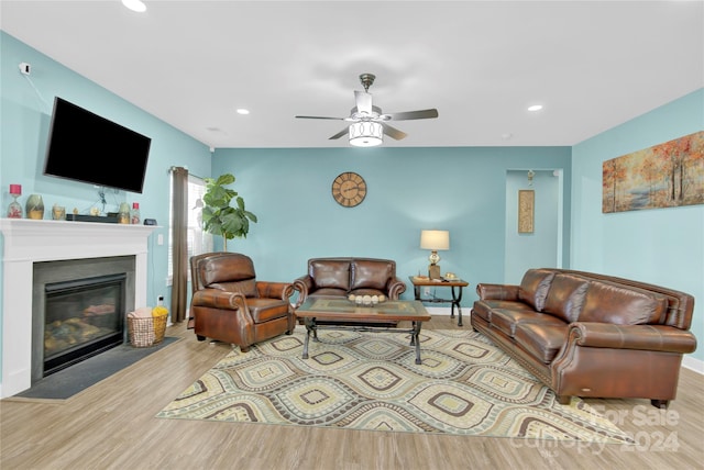 living room with ceiling fan and light hardwood / wood-style flooring