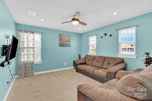 carpeted living room featuring ceiling fan