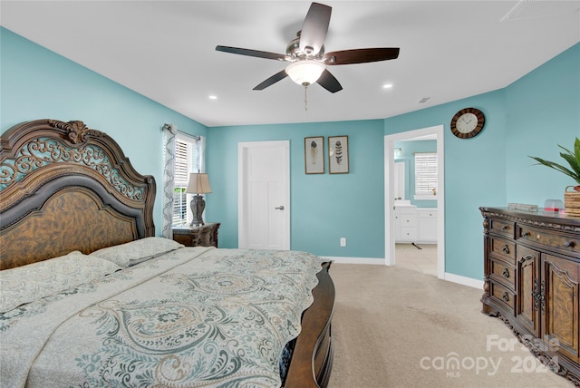 bedroom featuring ensuite bath, ceiling fan, and light colored carpet