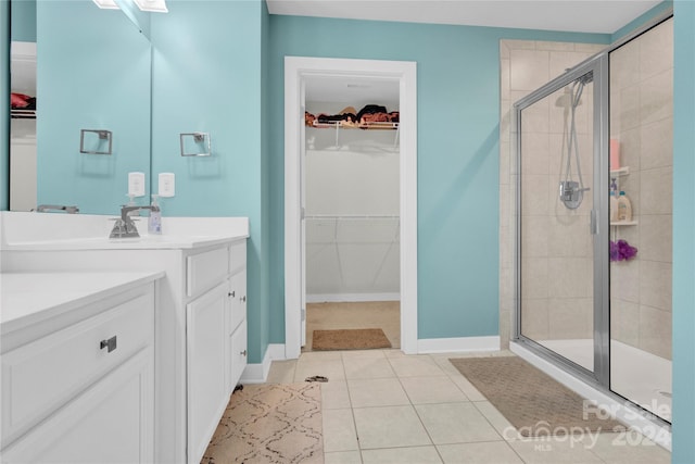 bathroom featuring tile patterned flooring, vanity, and an enclosed shower