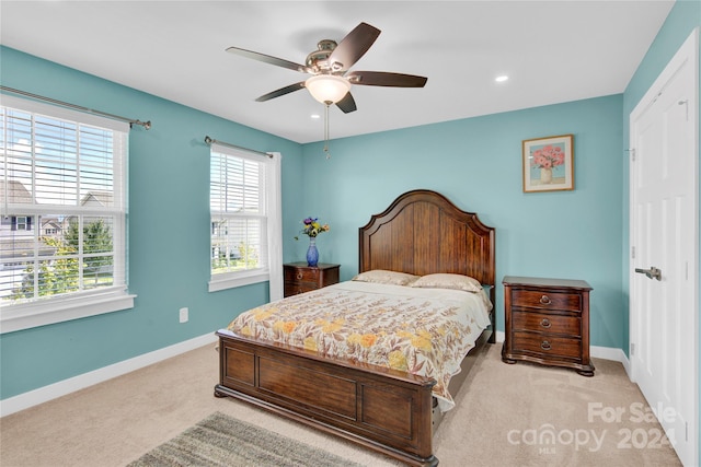 bedroom featuring ceiling fan and light colored carpet