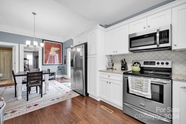 kitchen featuring dark hardwood / wood-style floors, decorative backsplash, white cabinetry, and stainless steel appliances