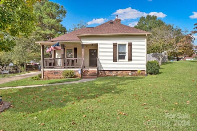 bungalow featuring a front yard and covered porch