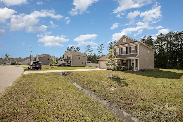 view of front facade with a front lawn, a residential view, and concrete driveway