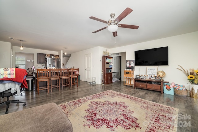 living room featuring ceiling fan and wood finished floors