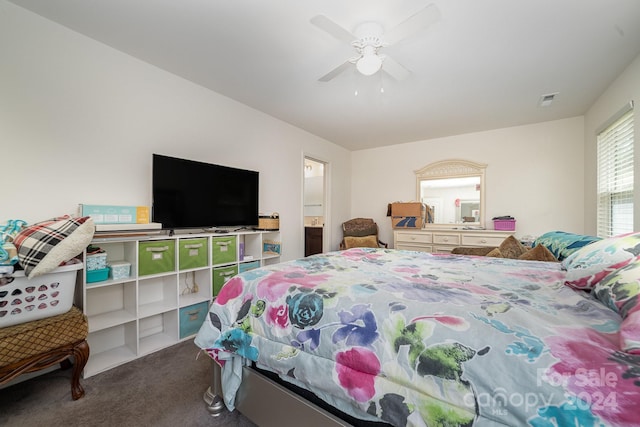 carpeted bedroom featuring ceiling fan, ensuite bath, and visible vents
