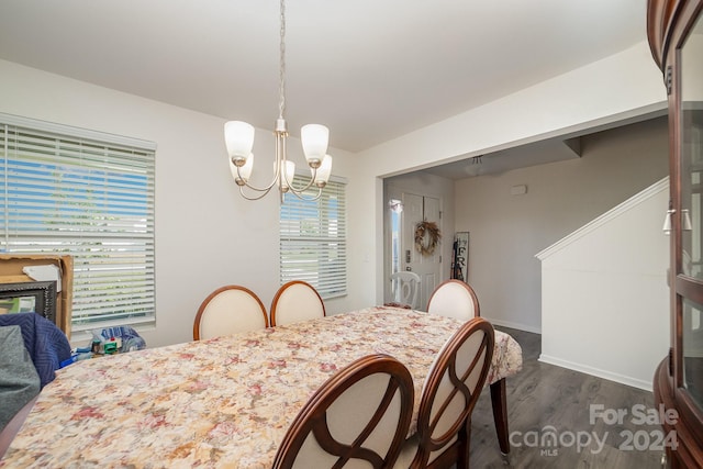 dining area with baseboards, a chandelier, and dark wood-style floors