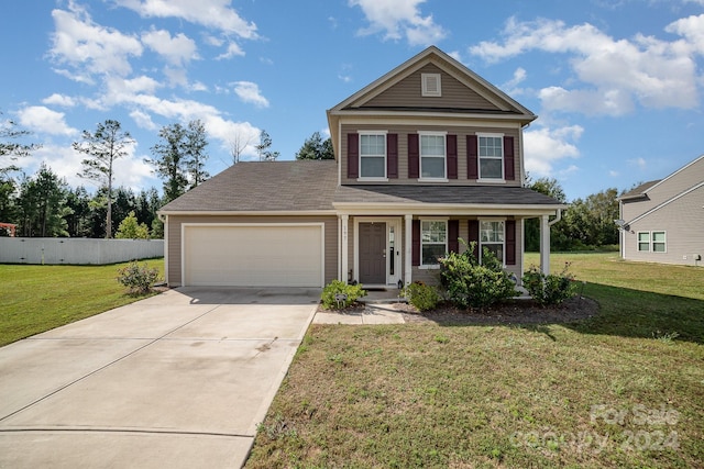 view of front of property with a garage, a porch, and a front lawn