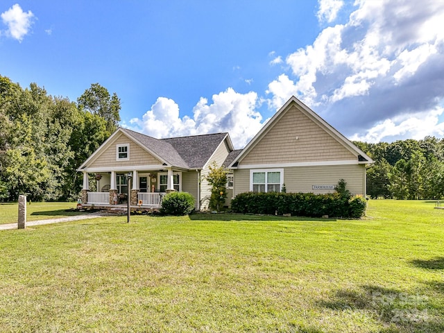 view of front facade with a front yard and covered porch