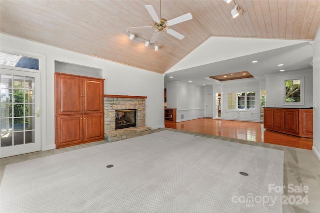 unfurnished living room with wooden ceiling, a fireplace, vaulted ceiling, and ceiling fan