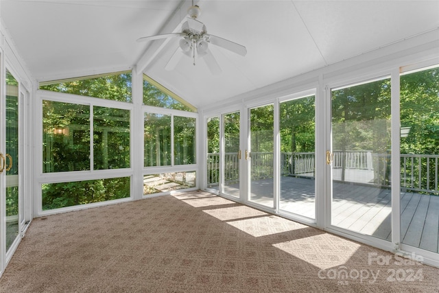 unfurnished sunroom with vaulted ceiling with beams and ceiling fan