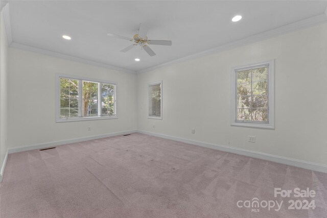 unfurnished room with light carpet, ceiling fan, and crown molding