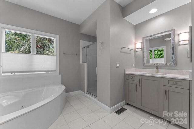 bathroom with vanity, plus walk in shower, and tile patterned flooring