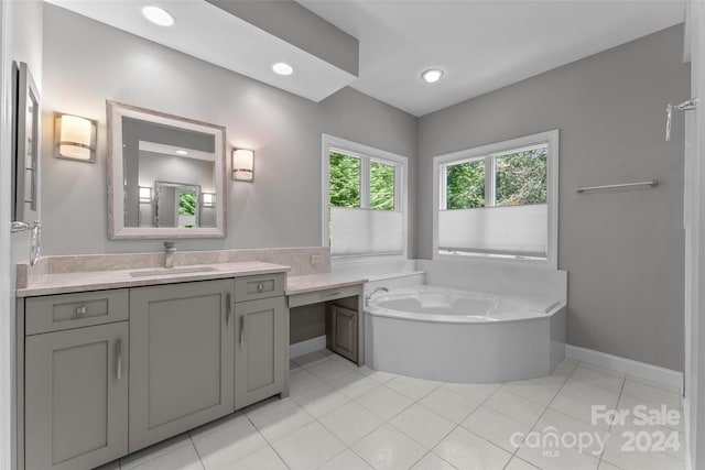 bathroom with vanity, tile patterned floors, and a bathtub