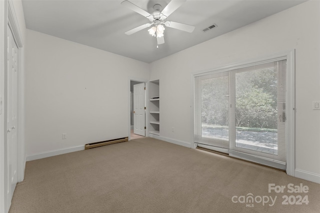 unfurnished bedroom featuring ceiling fan, light colored carpet, and a baseboard heating unit