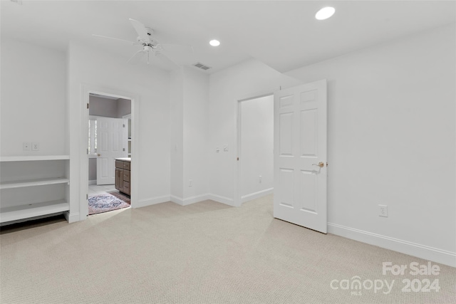 empty room featuring light carpet and ceiling fan