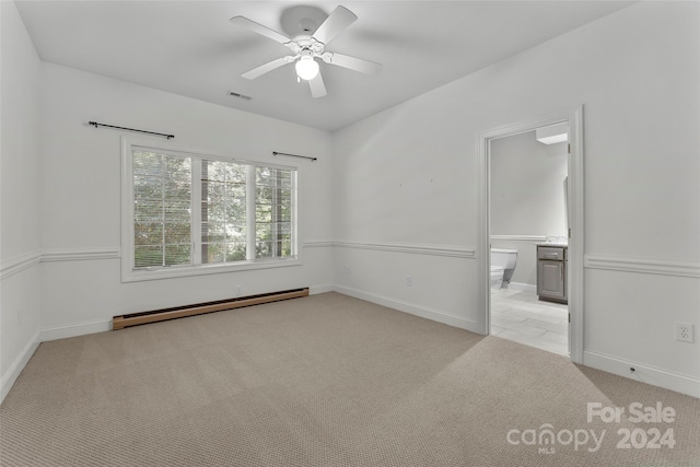 carpeted empty room with ceiling fan and baseboard heating