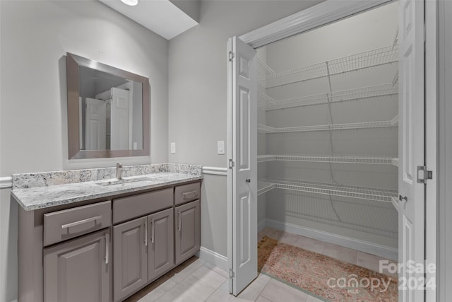 bathroom with tile patterned flooring and vanity