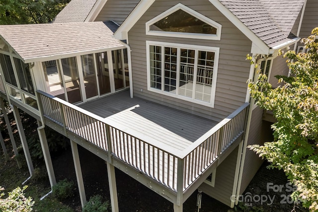 wooden deck with a sunroom