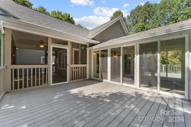 wooden deck featuring a sunroom