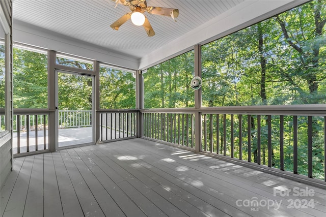 unfurnished sunroom featuring ceiling fan