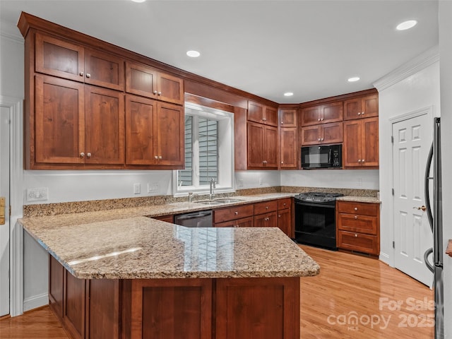 85 Tall Poplar Smt, Hendersonville, NC 28739 - kitchen with black appliances, a peninsula, light wood finished floors, light stone counters, and recessed lighting