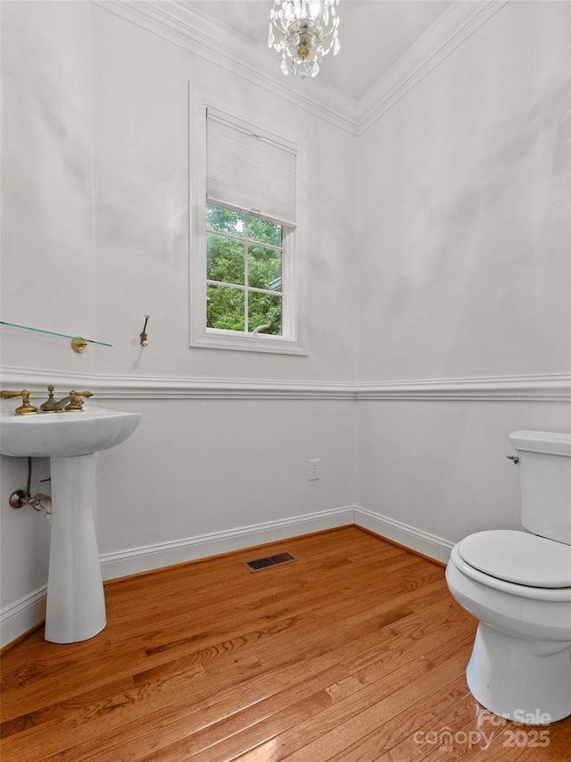 85 Tall Poplar Smt, Hendersonville, NC 28739 - half bath with wood finished floors, ornamental molding, and a chandelier