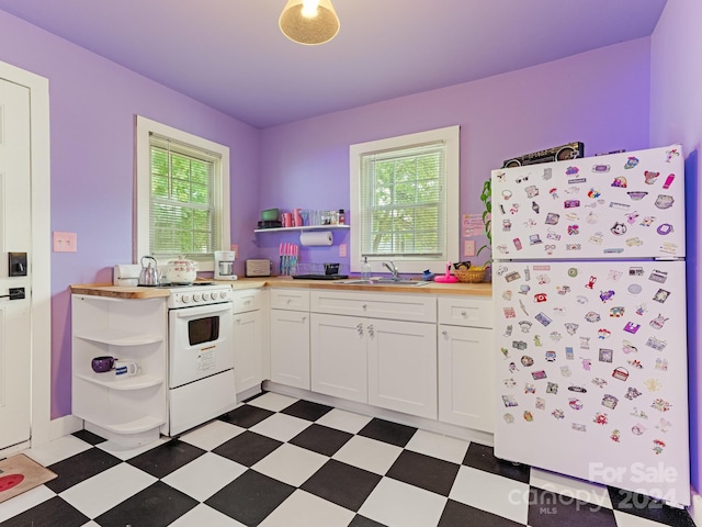 kitchen with white cabinets, sink, and white appliances