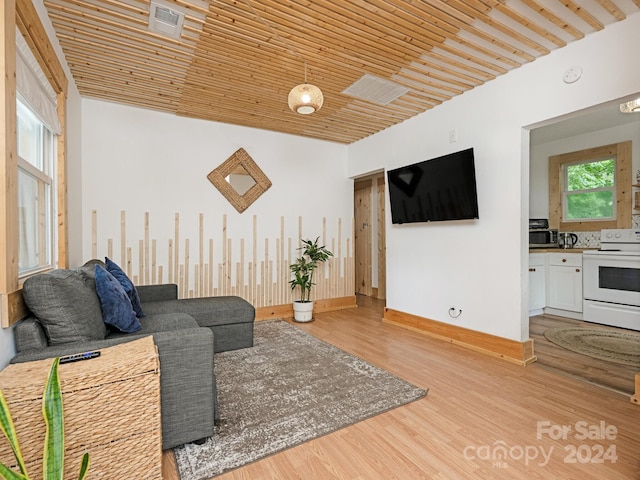 living room featuring light hardwood / wood-style flooring and wood ceiling