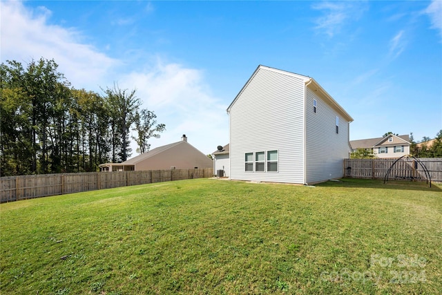 rear view of property featuring a yard